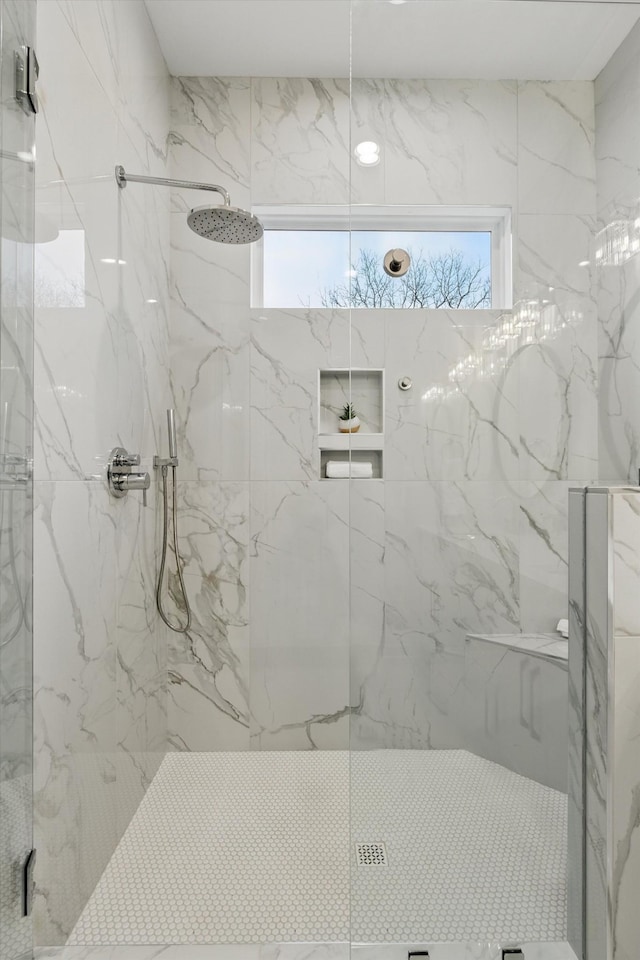 full bathroom with a marble finish shower