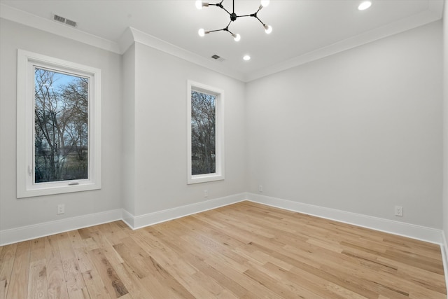 spare room with baseboards, crown molding, visible vents, and a notable chandelier