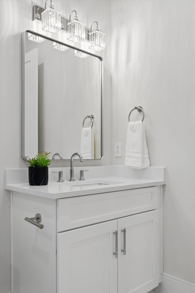 bathroom with baseboards and vanity