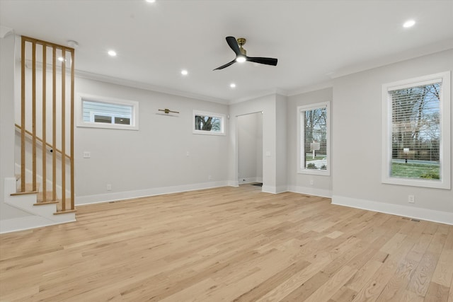 empty room featuring stairway, light wood-style flooring, ornamental molding, and baseboards