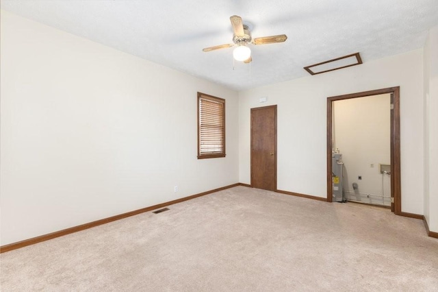 interior space featuring light carpet, electric water heater, and ceiling fan