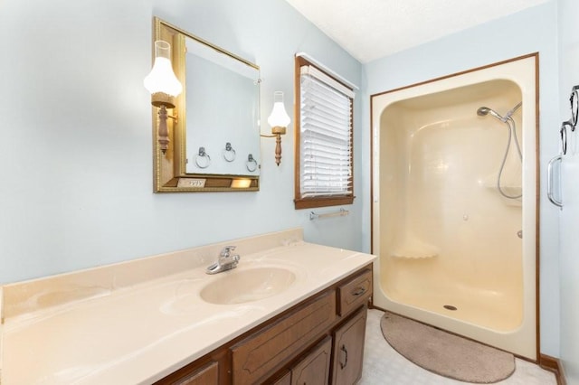 bathroom with vanity and a shower