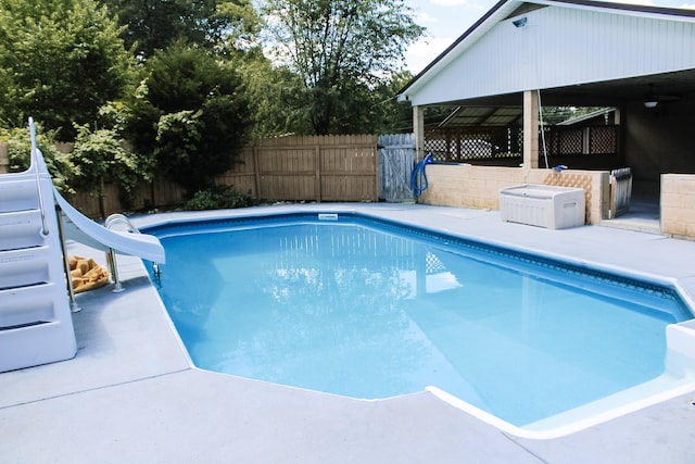 view of swimming pool with a water slide