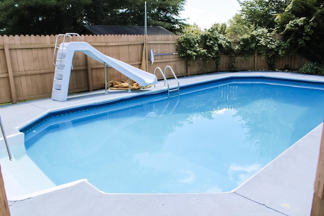 view of pool with a water slide