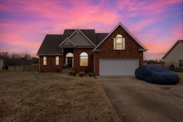 front of property featuring a garage and a yard