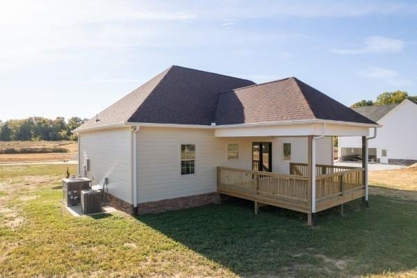 back of house featuring cooling unit, a yard, and a deck