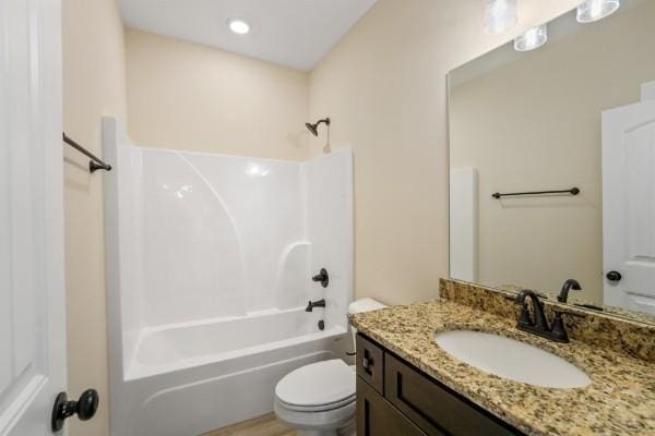 full bathroom with shower / bath combination, vanity, and toilet