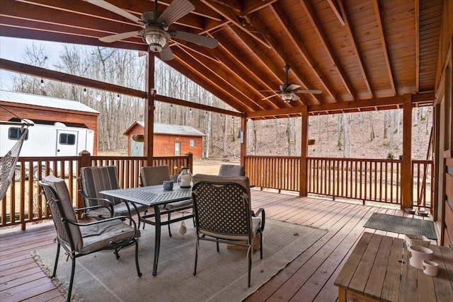 deck with ceiling fan and a shed