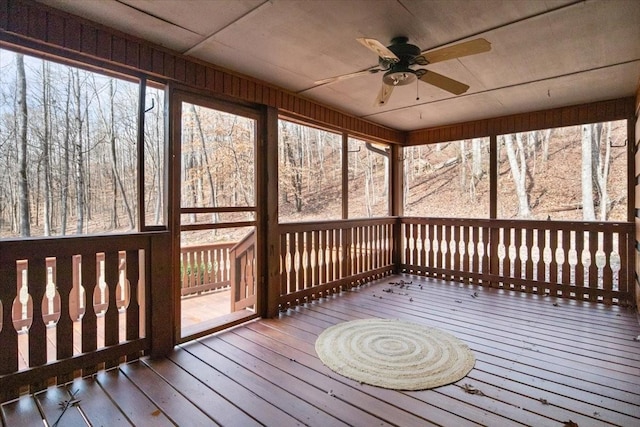 unfurnished sunroom with plenty of natural light and ceiling fan