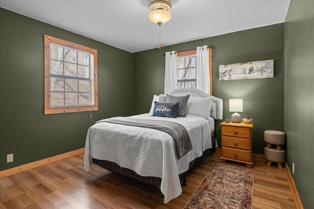 bedroom with hardwood / wood-style flooring