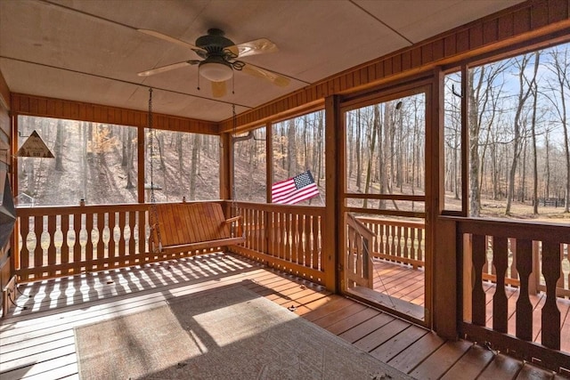 unfurnished sunroom with ceiling fan and a wealth of natural light