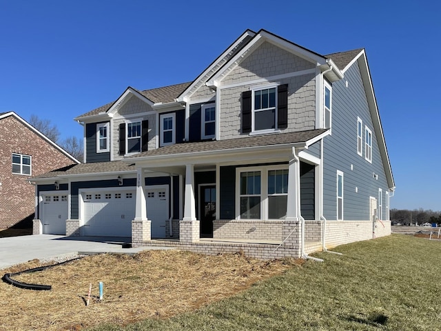 craftsman-style home featuring a garage, a front lawn, and a porch