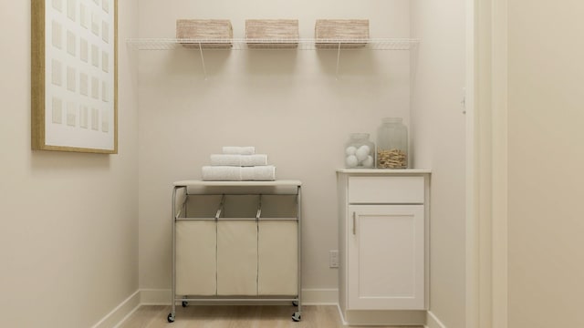 laundry room featuring light wood-type flooring