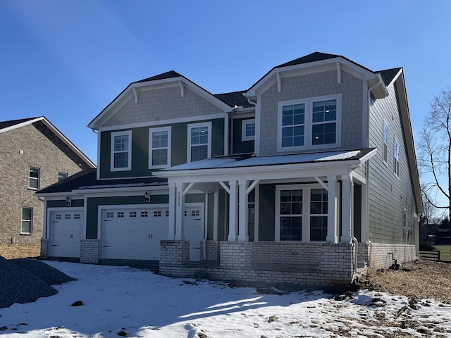 craftsman inspired home featuring a garage and a porch