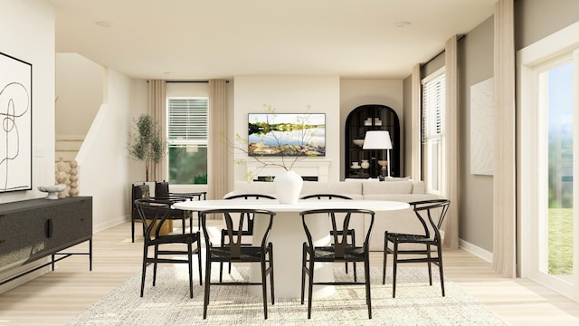 bar with plenty of natural light and light hardwood / wood-style flooring