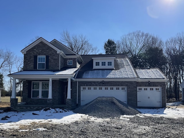 view of front of property with a garage and covered porch