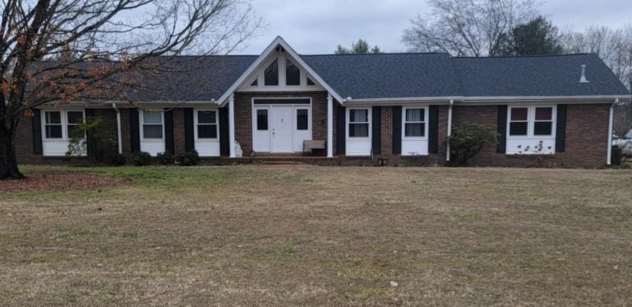 ranch-style home with a front yard