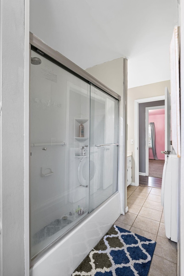 bathroom featuring tile patterned flooring, shower / bath combination with glass door, and vanity