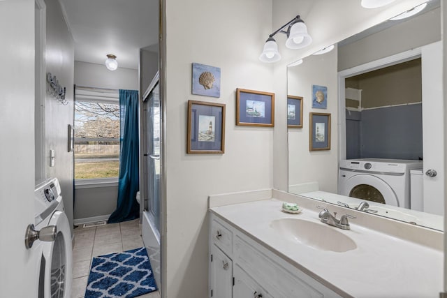 bathroom with tile patterned floors, washer / dryer, and vanity