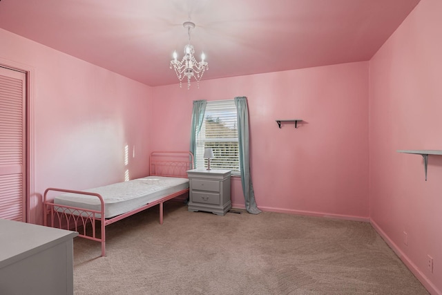 carpeted bedroom featuring a notable chandelier