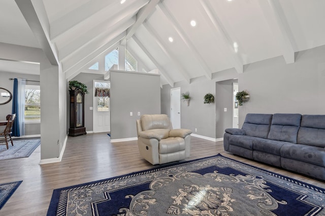 living room with high vaulted ceiling, hardwood / wood-style flooring, and beam ceiling