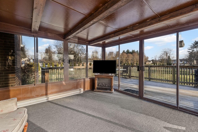 sunroom with a baseboard heating unit, plenty of natural light, and beam ceiling