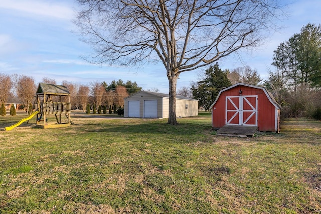 view of yard featuring a shed, a playground, and a garage