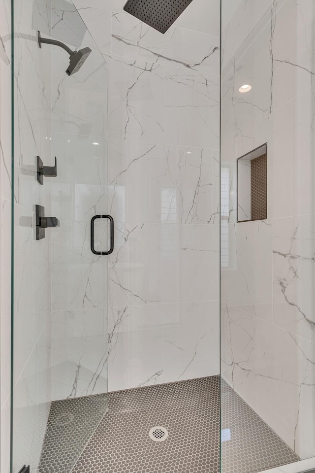 bathroom with a shower with door