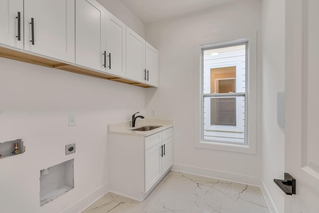 laundry area with cabinets, hookup for an electric dryer, hookup for a washing machine, and sink