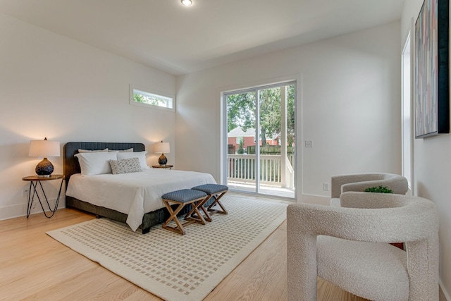 bedroom with wood-type flooring and access to outside