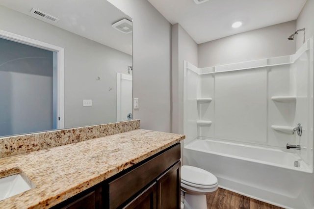 full bathroom with hardwood / wood-style flooring, vanity, toilet, and tub / shower combination