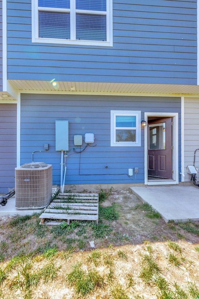 property entrance with a patio and central air condition unit