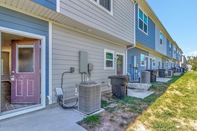 exterior space featuring a patio, a yard, and cooling unit