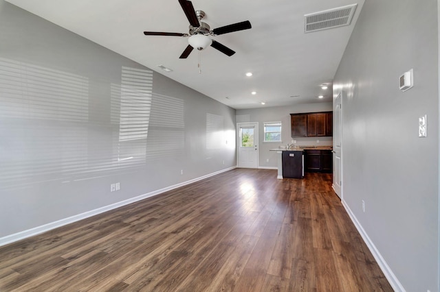 unfurnished living room with dark wood-type flooring and ceiling fan