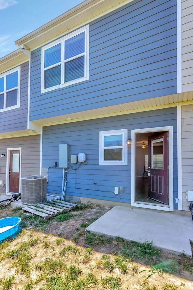 rear view of house featuring a patio and central AC unit