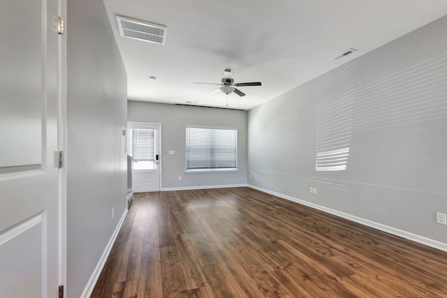 unfurnished room featuring dark hardwood / wood-style floors and ceiling fan