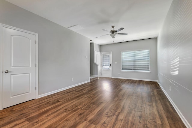 unfurnished room featuring dark hardwood / wood-style flooring and ceiling fan