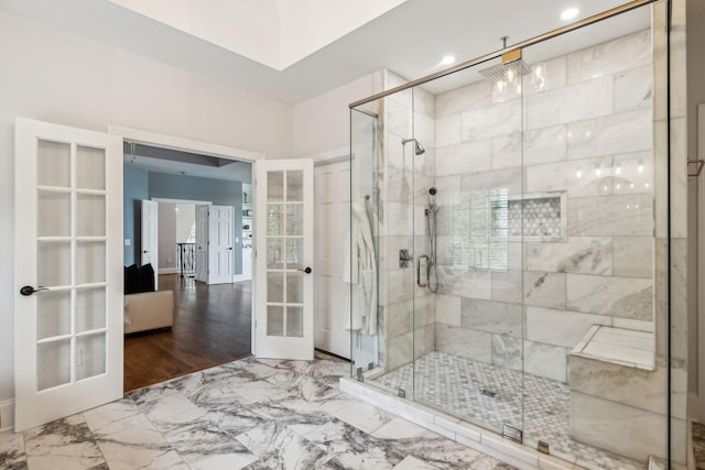 bathroom with a shower with shower door and french doors