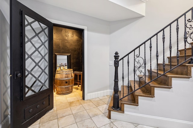 foyer entrance featuring light tile patterned flooring