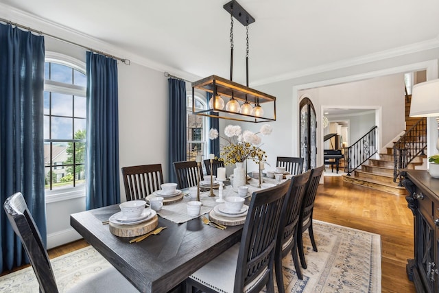 dining space with crown molding and wood-type flooring