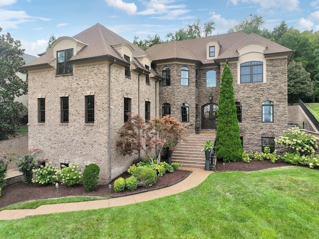 french provincial home with a front lawn