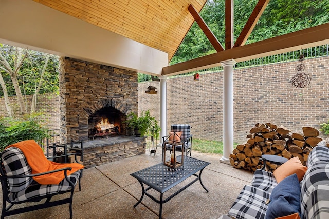 view of patio / terrace featuring an outdoor stone fireplace