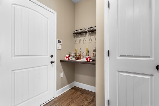 interior space featuring dark hardwood / wood-style floors and bar area