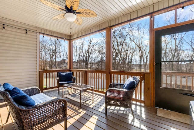 sunroom / solarium featuring ceiling fan