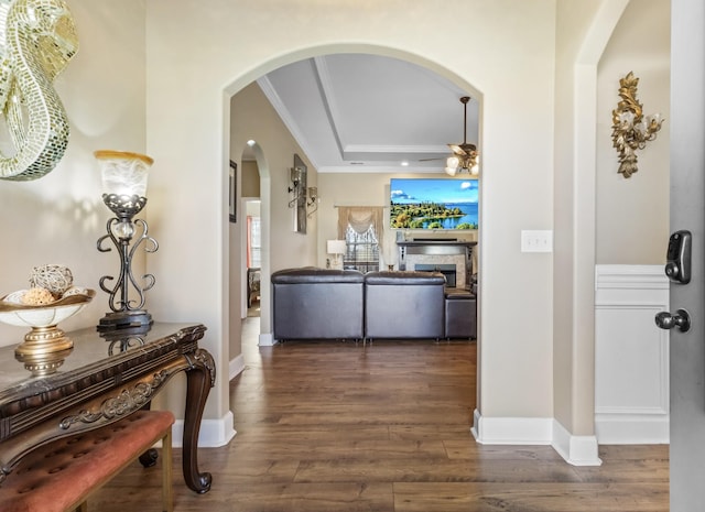 hallway with dark wood-type flooring and ornamental molding