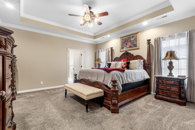 carpeted bedroom featuring ceiling fan, ornamental molding, and a raised ceiling