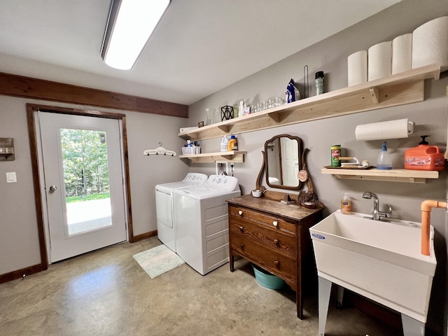 clothes washing area with sink and washer and dryer