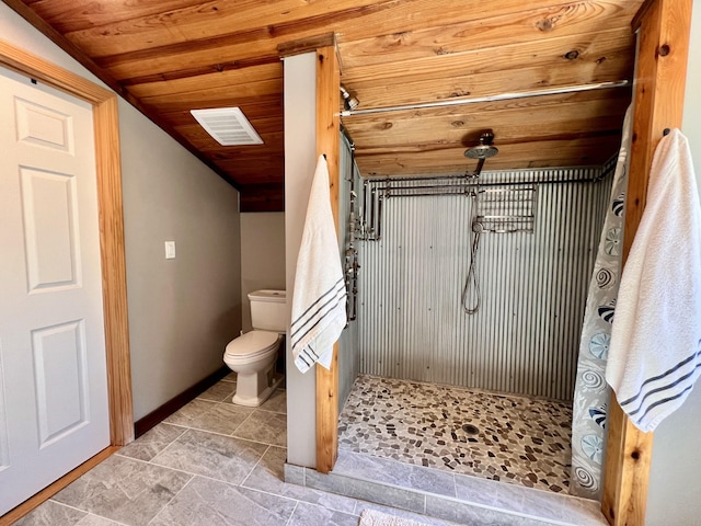 bathroom with wood ceiling, lofted ceiling, toilet, and walk in shower