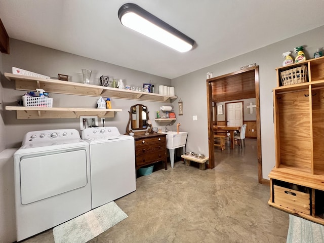 laundry area with separate washer and dryer and sink