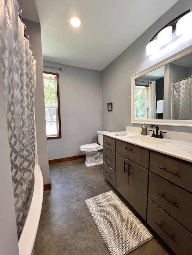 bathroom featuring vanity, toilet, and concrete floors